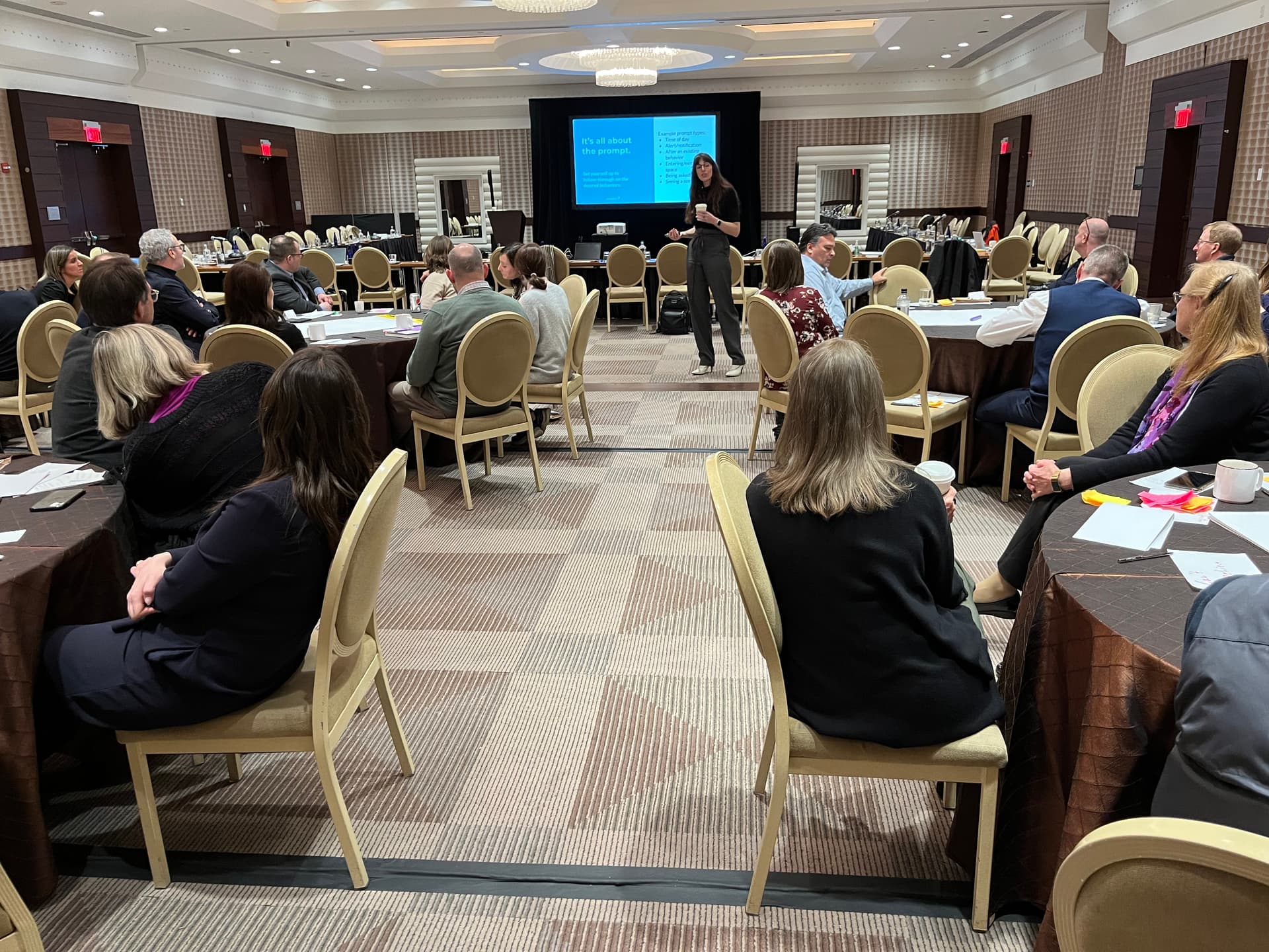 Mamie Kanfer Stewart leading a workshop with a room full of participants