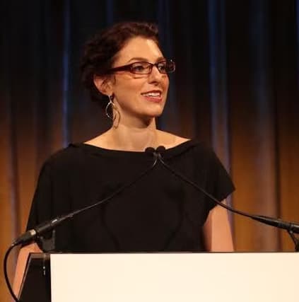 Mamie Kanfer Stewart speaking on stage at Lives of Commitment